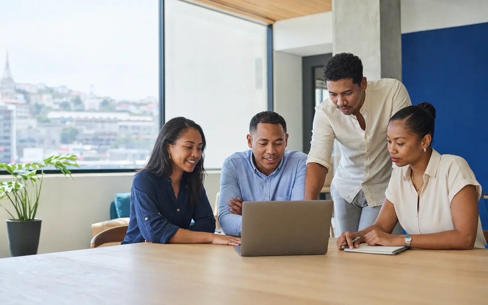 A professional team gathered around a workstation